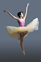 Ballerina is dancing on a gray Premium Photo