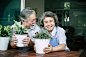 Elderly couples talking together and plant a trees in pots.
