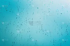 特写雨滴在窗户玻璃表面与阳光和树的背景。下雨天的孤独。