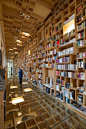 Mexican firm Taller 6A has renovated a library inside an eighteenth-century building in Mexico City, adding a bookshop with hundreds of wooden boxes on its walls, its ceilings, and under its glass floor