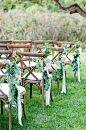 Greenery with cream ribbons is simple, lovely aisle decor | @angiesilvy | Brides.com: 