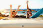 Women cheering in convertible on beach by Gable Denims on 500px