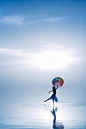 Young ballerina dancing with color umbrella on the salt lake创意图片素材 - E+