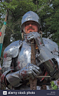 closeup-of-man-in-suit-of-shining-armour-holding-sward-at-medieval-AK1GP2.jpg (864×1390)
