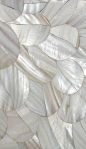 a close up view of white leaves on a surface that looks like it has been made out of shells