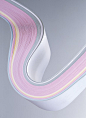 Multi coloured pile of curved paper, close-up