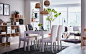 A beige, black and white dining area in an open-plan living space with white upholstered HENRIKSDAL chairs and EKEDALEN extendable table.