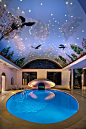 indoor pool oasis, clamshell sculpture and mural painted barrel-vault ceiling