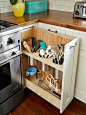 This pull-out utensil bin, right next to the stove, is a clever alternative to the traditional corner-cabinet lazy Susan.: 