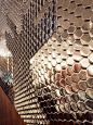 The reflective hexagonal ceramic tile created five stag silhouettes composed across an 11m long reception wall at the Sheraton Hotel in Edinburgh - by Giles Miller Studio: 