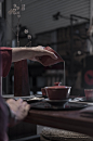 person pouring liquid on cup