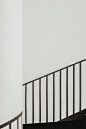 shadow of stair rails on white painted wall