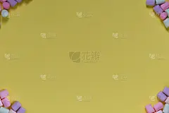 黄色背景上的彩色棉花糖框架。旗帜,明信片。俯视图，复制空间。