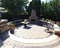 Large traditional back patio in Chicago with with a fire feature, natural stone paving and no cover.