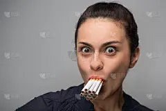 上瘾。年轻迷人的女人与香烟的特写。曲