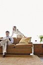 Older Caucasian couple reading book on sofa by Gable Denims on 500px