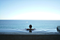 A woman bathing in a pool overlooking a vast blue ocean