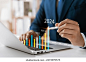 Businessman analyzes profitability of working companies with digital augmented reality graphics, positive indicators in 2024, businessman calculates financial data for long-term investments.