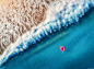 Aerial view of young woman swimming on the pink swim ring