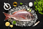 Fresh red porgy fish and ingredients on ice on a black stone tab by Kamil Zabłocki on 500px