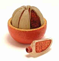 1925 De Marcy "L'Orange Variée" perfume presentation, complete as a peeled orange of painted composition, holding 8 glass bottles with labels.