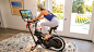Woman riding BowFlex VeloCore Bike - default view