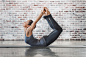 Young Woman Doing Yoga Meditation and Stretching Exercises