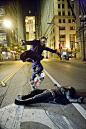 The Joker skateboarding over Batman