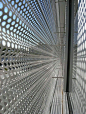 Undulating perforated metal screen: 