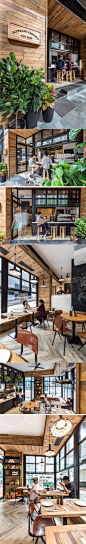 This cafe has a simple color palette of wood, white and black, with a touch of green from the plants.