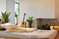 Guitar leaning near fireplace behind chaise in living room by Caia Images on 500px