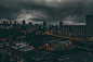 time-lapse photography of city under black cloudy sky