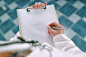 Female doctor in white uniform writing on clipboard paper by Igor Stevanovic on 500px